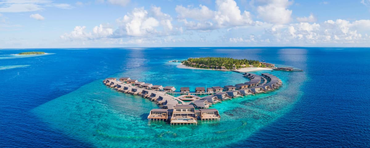 The St. Regis Maldives Vommuli Resort — aerial view of the private island and overwater villas
